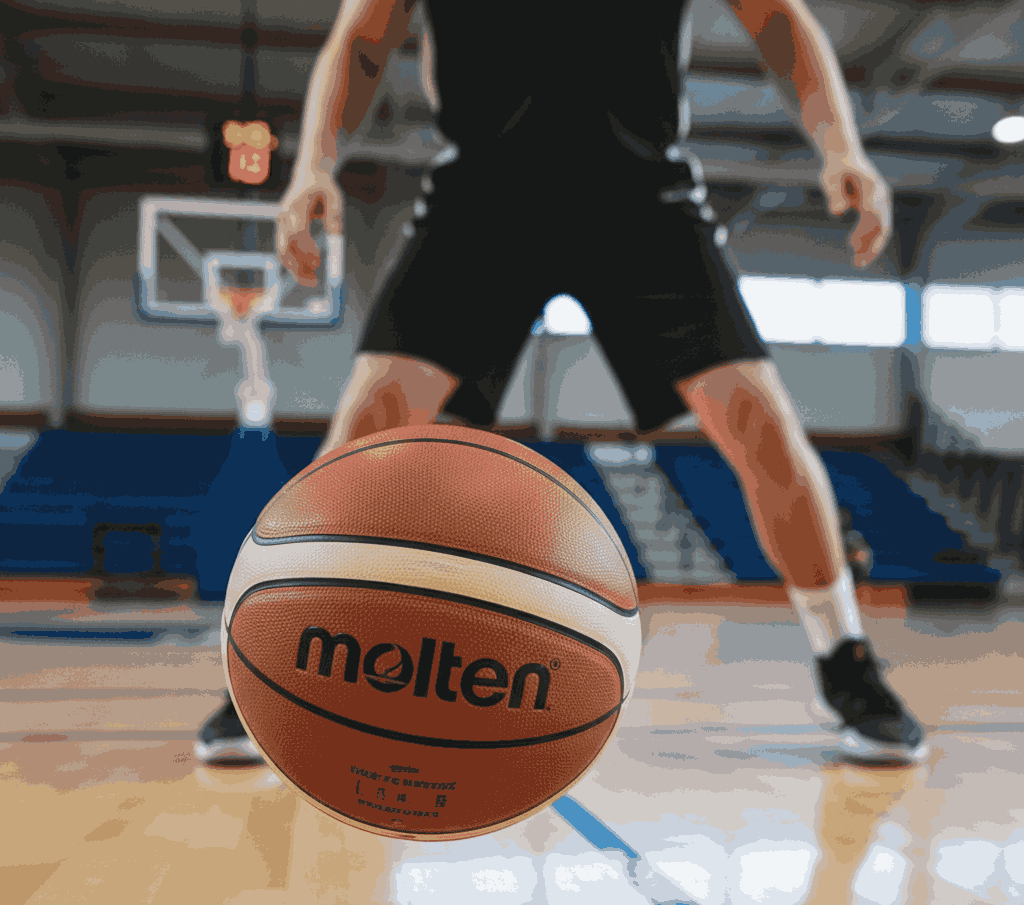 Molten BG5000 basketball on court with player dribbling, highlighting official FIBA game ball