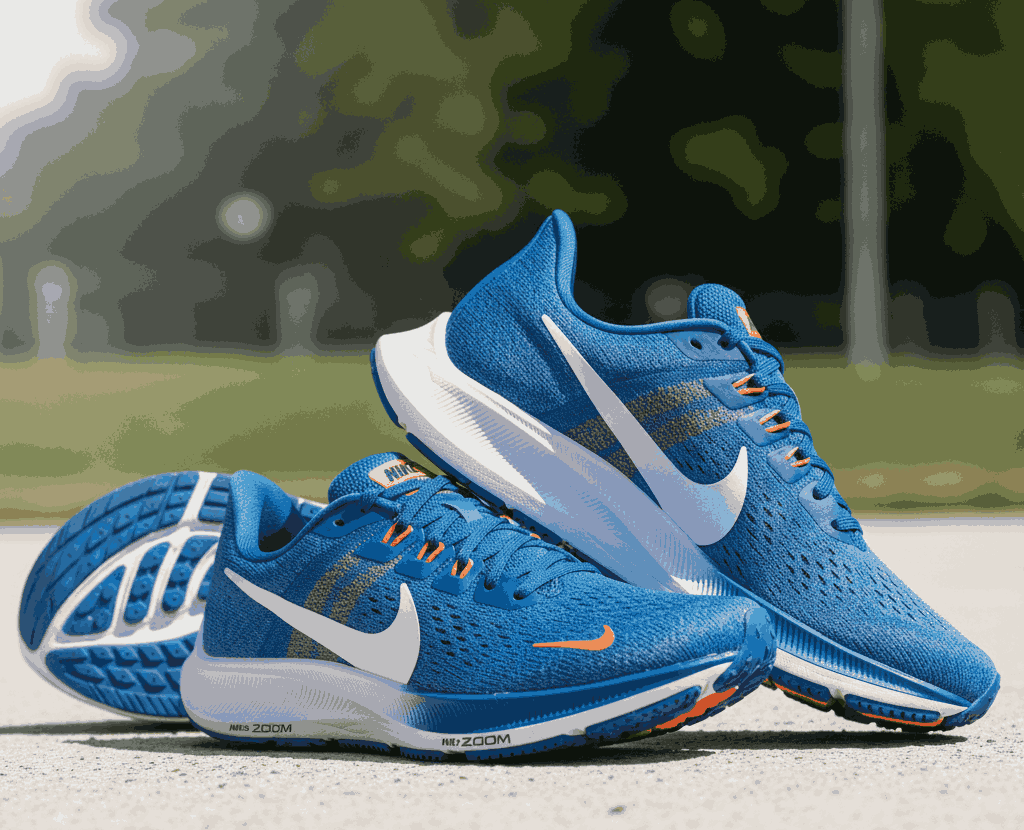 Blue Nike running shoes with white swoosh and orange accents on outdoor court