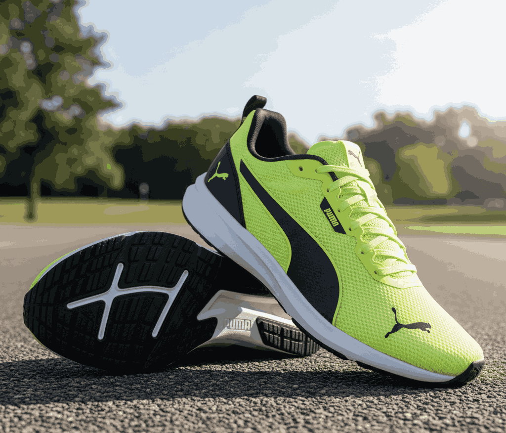 Neon yellow Puma running shoes with black logo and white sole outdoors
